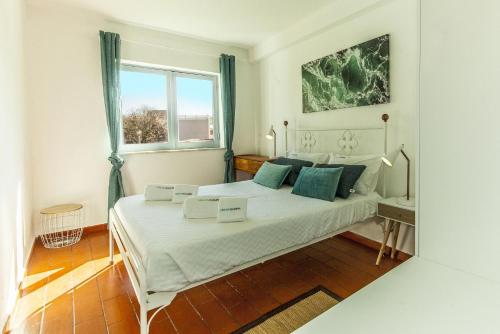 a bedroom with a large white bed with blue pillows at B20 - Sun and Pool Apartment in Lagos