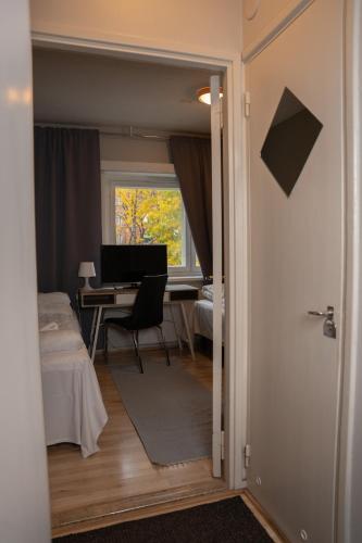 een kamer met een bed en een bureau met een computer bij Citimotel in Lappeenranta
