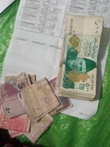 a pile of money sitting on top of a receipt at Hhxhd 