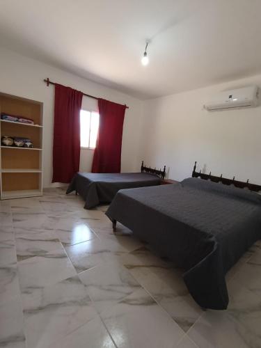 a bedroom with two beds and a window at La finca in Fiambalá