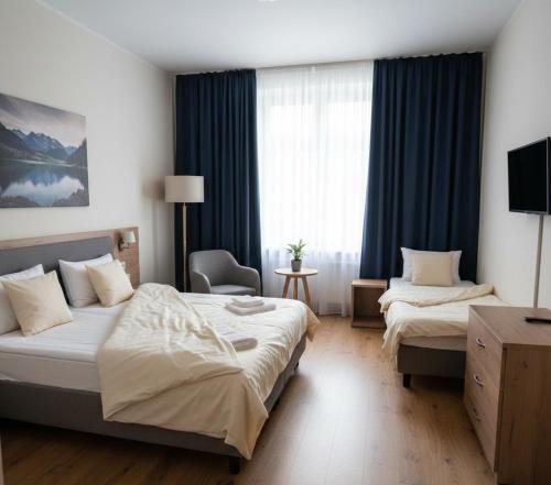 a hotel room with two beds and a window at Özlem Apart&Pansiyon in Hatay