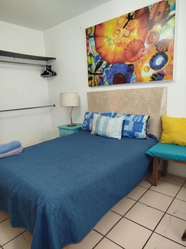 a bedroom with a blue bed and a chair at Habitación privada en casa de huespedes in Guadalajara