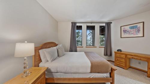 a bedroom with a bed and a dresser and a window at Sparrow by AvantStay Modern Mountain Retreat w Hot Tub Pool Table Games in Truckee