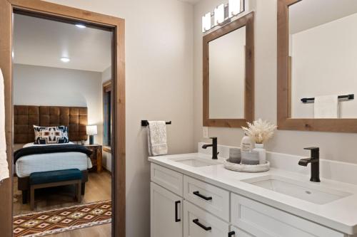 a bathroom with a sink and a bedroom at Alpine Basecamp in Red Lodge