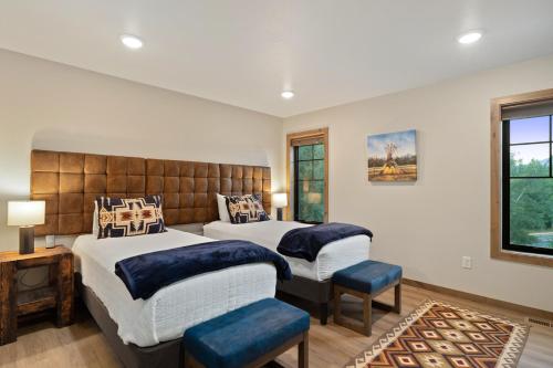a bedroom with two beds and a large window at Alpine Basecamp in Red Lodge