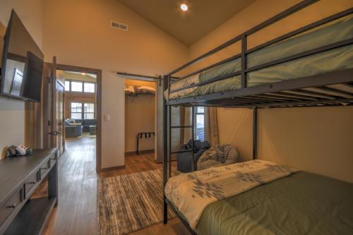 a bedroom with two bunk beds and a hallway at Ski Run View Red Lodge in Red Lodge