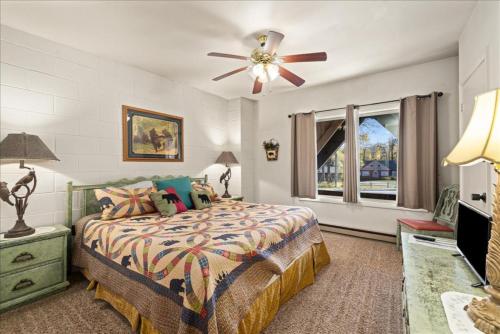 a bedroom with a bed and a ceiling fan at The Bears Den in Red Lodge