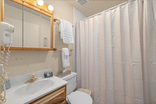 a bathroom with a sink and a toilet and a shower at Gunslinger Gateway Red Lodge in Red Lodge