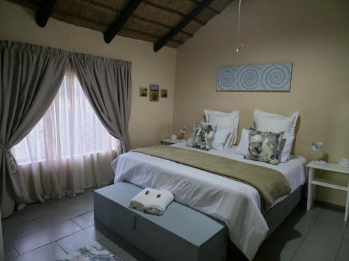 Ένα ή περισσότερα κρεβάτια σε δωμάτιο στο Loubad Guest Farm