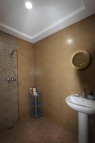a bathroom with a sink and a shower at Agadir Funky Chill Guesthouse Surf, Horse, Music adventures in Aourir
