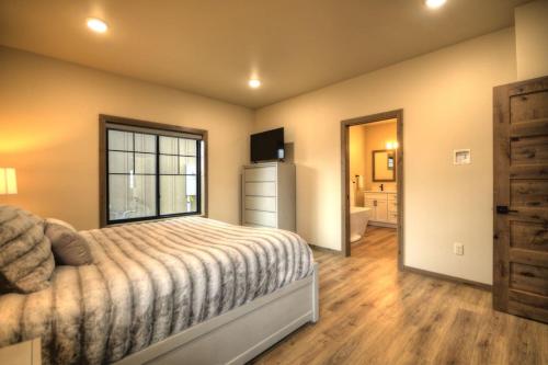 a bedroom with a bed and a large window at Yellowstone Yonder Red Lodge in Red Lodge