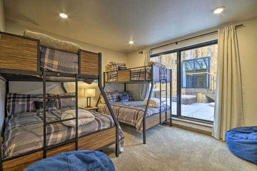 two bunk beds in a room with a window at Hauser House Unit 1 in Red Lodge