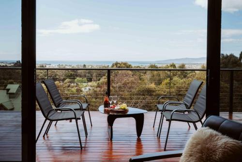 a patio with chairs and a table with a view at Panorama Escape, Port Sorell in Port Sorell