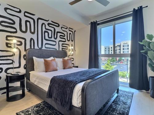 a bedroom with a bed and a large window at Quiet City Getaway Near Regions Field and Food in Birmingham