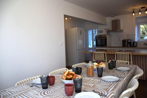 a table with a bowl of food on top of it at Ti An Eizh - Charming Townhouse - Near Vannes in Treffléan