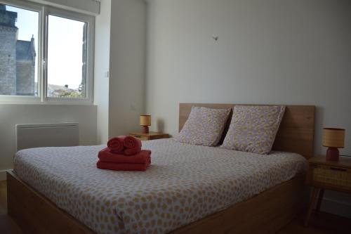 a bedroom with a bed with a red towel on it at Ti An Eizh - Charming Townhouse - Near Vannes in Treffléan