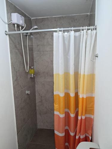 a bathroom with a shower curtain in a bathroom at Kaihalulu Beach Room - Punta Hermosa in Punta Hermosa