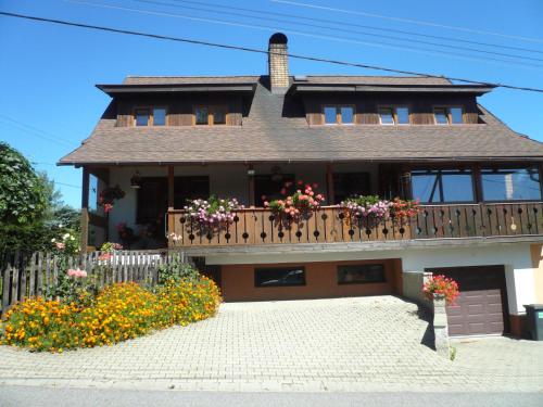 a house with a balcony with flowers on it at Apartmány Krásná - K68 in Jablonec nad Nisou