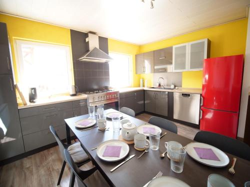 a kitchen with a table with chairs and a red refrigerator at Albsteig-Apartments Gruibingen in Gruibingen