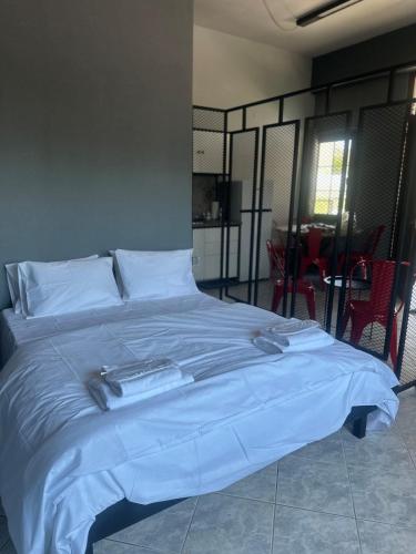 a large bed with a blue blanket on top of it at Letsios Steel1 in Kalabaka
