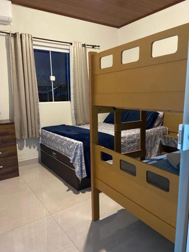 Кровать или кровати в номере Recanto dos Pássaros