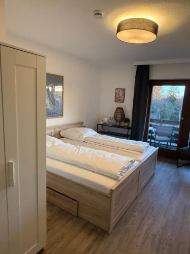 a bedroom with two beds and a window at Waldhotel Süllhof in Steyerberg