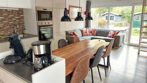 a kitchen and living room with a table and a couch at Vakantiehuis Ruby in Bruinisse