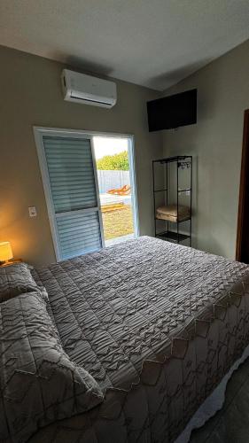 Ένα ή περισσότερα κρεβάτια σε δωμάτιο στο Suítes Brotas