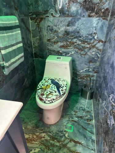 a bathroom with a toilet with a bird on it at 420 Suites & Blue Spa Bath in Washington, D.C.