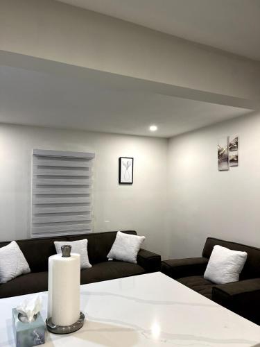 a living room with a couch and a table at Cozy 2-Bed with Kitchen and Patio in Midtown Toronto in Toronto
