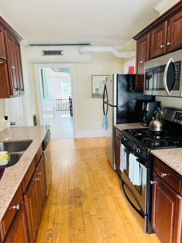 a kitchen with a stove and a refrigerator at Federal Hill Suites and Rooms in Providence