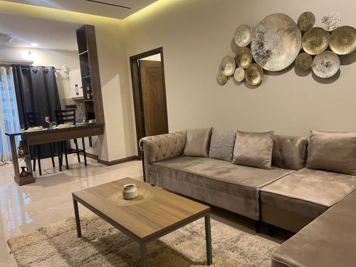 un soggiorno con un divano e un tavolo di Executive 1-Bed Luxury Apartment with City View ! Zeta Mall Islamabad a Islamabad