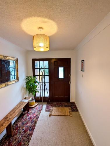 an empty hallway with a door and a potted plant at Tranquil Countryside Cottage near Loughborough
