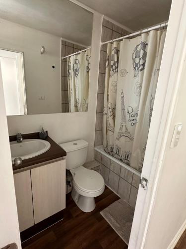 a bathroom with a toilet and a sink and a mirror at Beautiful Portal Santo Domingo Apartment in San Antonio