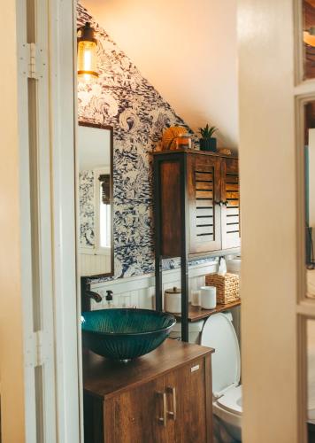 a bathroom with a green bowl on top of a counter at Jones Beach Houseboat in Seaford