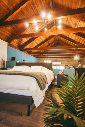 a bedroom with a large bed in a room with wooden ceilings at Jones Beach Houseboat in Seaford
