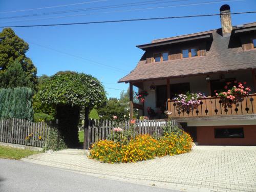 a house with a fence and flowers in front of it at Apartmány Krásná - K68 in Jablonec nad Nisou