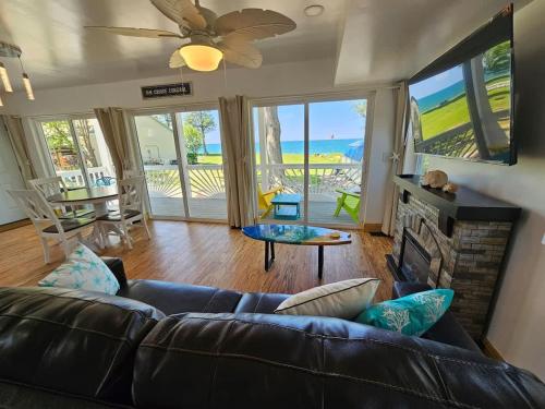 a living room with a couch and a fireplace at SeaSide Lake-Front Cottage in Madison