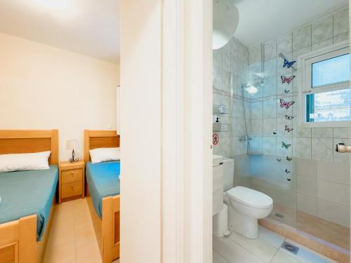 a bathroom with a toilet and a shower at Antonio 50 - Blue Glyfada Private Homes in Glyfada