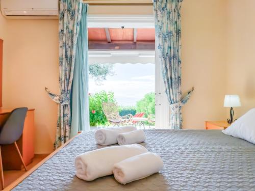 a bedroom with a bed with two towels on it at Antonio 50 - Blue Glyfada Private Homes in Glyfada