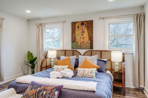 a bedroom with a large blue bed with pillows at Upscale Family Retreat Near DC and Georgetown! in North Bethesda