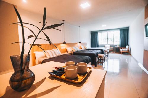 a living room with a table with cups on it at La Regina Lodge in Itatí