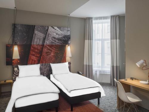 Ένα ή περισσότερα κρεβάτια σε δωμάτιο στο Ibis Riga Centre