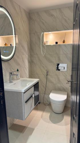 a bathroom with a sink and a toilet and a mirror at Suite Bahiya unica in Fez