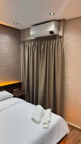 a bedroom with a bed with two towels on it at Suite Bahiya unica in Fez