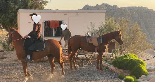 a woman riding a horse with hearts on its back at Dana luxury huts in Dana