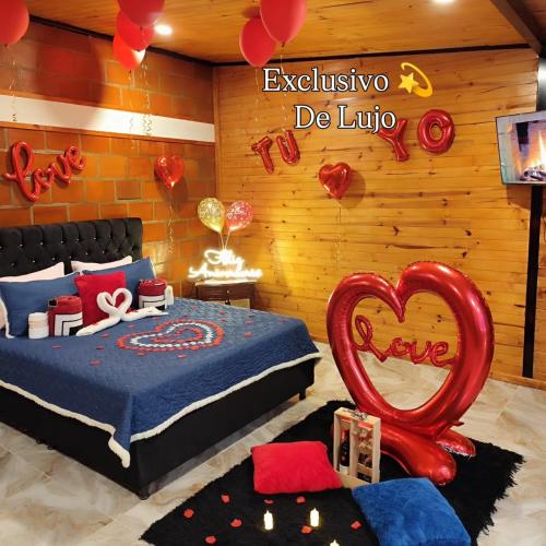 a bedroom with a bed with a heart in the middle at Glamping NOVA VILLA EL EDEN in Cali