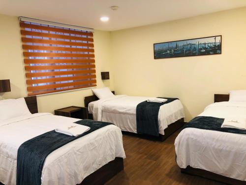 Ένα ή περισσότερα κρεβάτια σε δωμάτιο στο Urban Colonial