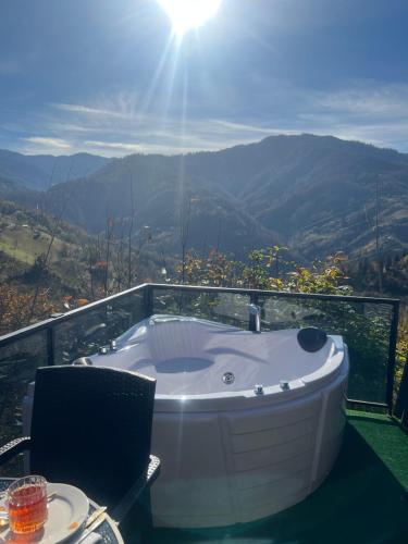a bath tub sitting on top of a balcony at Cottege Merisi's Side in Merisi