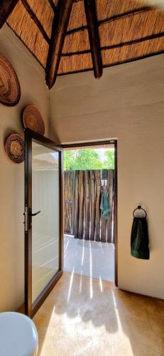 a room with a door open to a patio at Phumula Bushvilla in Phalaborwa